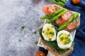 Toasts with spinach, boiled eggs and salted salmon, Cherry Tomato, Asparagus. Healthy Food Diet Royalty Free Stock Photo