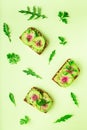 Toasts with watemelon radish, avocado and flex seeds Royalty Free Stock Photo