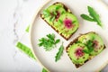 Toasts with watemelon radish, avocado and flex seeds Royalty Free Stock Photo