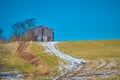 Tobacco barn sitting on a hill with snow covered path Royalty Free Stock Photo