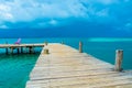Tobacco Caye - Relaxing on Wooden Pier on small tropical island at Barrier Reef with paradise beach, Caribbean Sea, Belize, Royalty Free Stock Photo