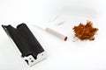 Tobacco roll machine filter white background Royalty Free Stock Photo