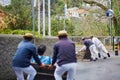 Toboggan riders moving cane sledge downhill on the streets of Funchal, Madeira island Royalty Free Stock Photo