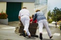 Toboggan riders moving cane sledge downhill on the streets of Funchal, Madeira island Royalty Free Stock Photo