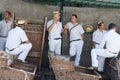 Toboggan sledge riders waiting for tourists in Madeira, Portugal