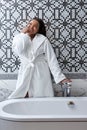 Today is my perfect day. Portrait of delightful pretty young african woman preparing bath at home, Royalty Free Stock Photo