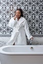 Today is my perfect day. Portrait of pretty young african woman preparing bath at home, Royalty Free Stock Photo