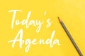 Today``s agenda concept with pencil on yellow background