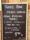 TodayÃ¢â¬â¢s menu in Spanish on blackboard outside in the street for a Tapas bar