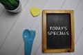 Today`s Specials write on a chalkboard isolated on office desk Royalty Free Stock Photo