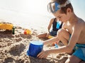 Today a sandcastle, tomorrow a high rise building. an adorable little boy and girl playing with toys in the sand at the Royalty Free Stock Photo