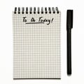 Today - to do list on gridded spiral notepad with pen, urgent - isolated on white