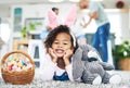 Today was egg-stra special. Shot of a young girl sitting on the floor with easter eggs at home.