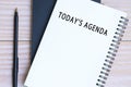 Today's agenda text on notepad with pen on wooden desk. Royalty Free Stock Photo