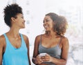 Todays class was great. two young women looking at a cellphone after yoga class. Royalty Free Stock Photo