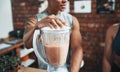 Todays the first day of their new diet. two unrecognizable sportspeople making fruit milkshake while working in a gym.