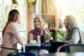 On todays menu Good friends and good times. a group of women chatting over coffee in a cafe.