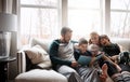 Todays story has a happy ending. two adorable brothers reading a book together with their parents while relaxing on the Royalty Free Stock Photo