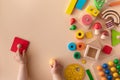 Toddler activity for motor and sensory development. Baby hands with colorful wooden toys on table top view Royalty Free Stock Photo