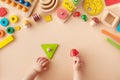 Toddler activity for motor and sensory development. Baby hands with different colorful wooden toys on table top view Royalty Free Stock Photo