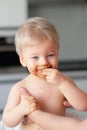 Toddler baby boy child eating fruit with dirty messy face Royalty Free Stock Photo