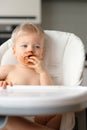 Toddler baby boy child eating fruit with dirty messy face Royalty Free Stock Photo