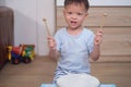 Toddler baby boy child hold sticks & plays a musical instrument drum Royalty Free Stock Photo