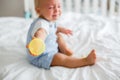 Toddler baby boy, playing with dummy, crying unhappy for the pac Royalty Free Stock Photo