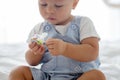 Toddler baby boy, playing with dummy, crying unhappy for the pacifier Royalty Free Stock Photo