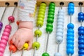 Toddler baby boy plays with his hands with colorful abacus on the floor, child with a toy in rainbow colors Royalty Free Stock Photo