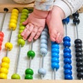 Toddler baby boy plays with his hands with colorful abacus on the floor, child with a toy in rainbow colors Royalty Free Stock Photo