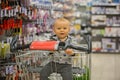 Toddler baby boy, sitting in a shopping cart in grocery store, s Royalty Free Stock Photo