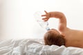 Toddler baby drink water from blue plastic bottle. Sitting on white background. Copy space Royalty Free Stock Photo