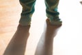 Toddler or baby feet clothed with dramatic light