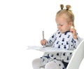 Toddler baby girl learning how to write on a paper book with pen Royalty Free Stock Photo