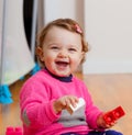 Toddler baby girl playing with rubber building blocks. Royalty Free Stock Photo