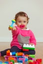 Toddler baby girl playing with rubber building blocks. Royalty Free Stock Photo