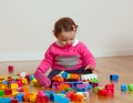 Toddler baby girl playing with rubber building blocks. Royalty Free Stock Photo