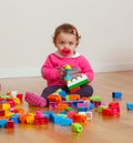 Toddler baby girl playing with rubber building blocks. Royalty Free Stock Photo