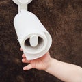 Toddler baby reaches for toilet paper, child s hand with hygiene produc Royalty Free Stock Photo