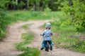 Toddler boy with balance bike at countryside fields forests Royalty Free Stock Photo