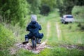 Child riding bike through a puddle creating a splash Royalty Free Stock Photo