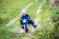 Child riding bike through a puddle creating a splash Royalty Free Stock Photo