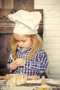 Toddler boy in chef hat and flour kneading dough Royalty Free Stock Photo