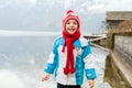 Toddler boy, child, standing on the edge of the lake in Hallstadt, Austria Royalty Free Stock Photo