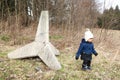 Toddler boy by concrete anti-tank barriers from World War Two