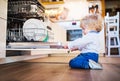 Toddler boy in dangerous situation at home. Child safety concept. Royalty Free Stock Photo