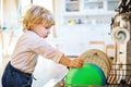 Toddler boy in dangerous situation at home. Child safety concept. Royalty Free Stock Photo