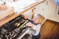 Toddler boy in dangerous situation at home. Child safety concept. Royalty Free Stock Photo