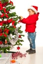 Toddler boy decorate Xmas tree